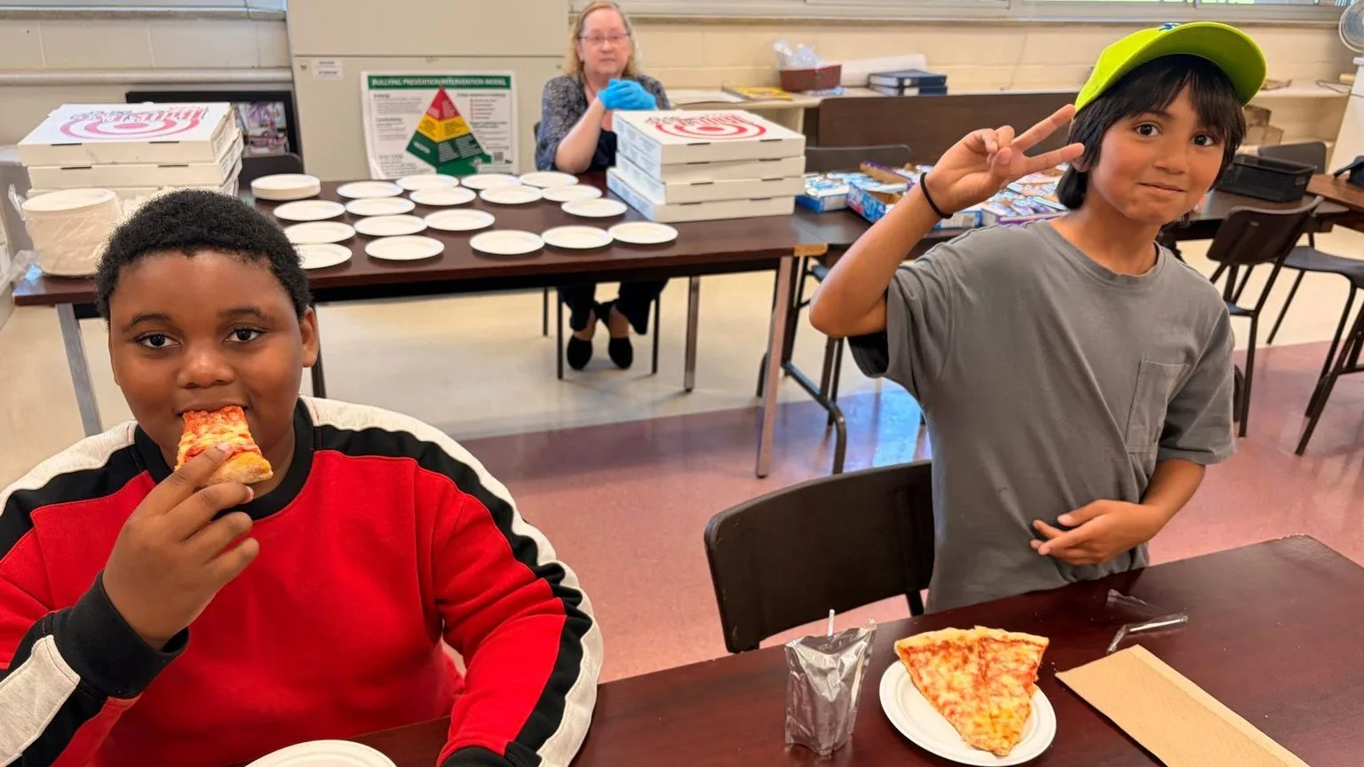 Two young people sharing a meal at a table during a partner-run community night.