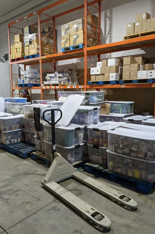 Shelves of sorted supplies in a partner organization's warehouse.